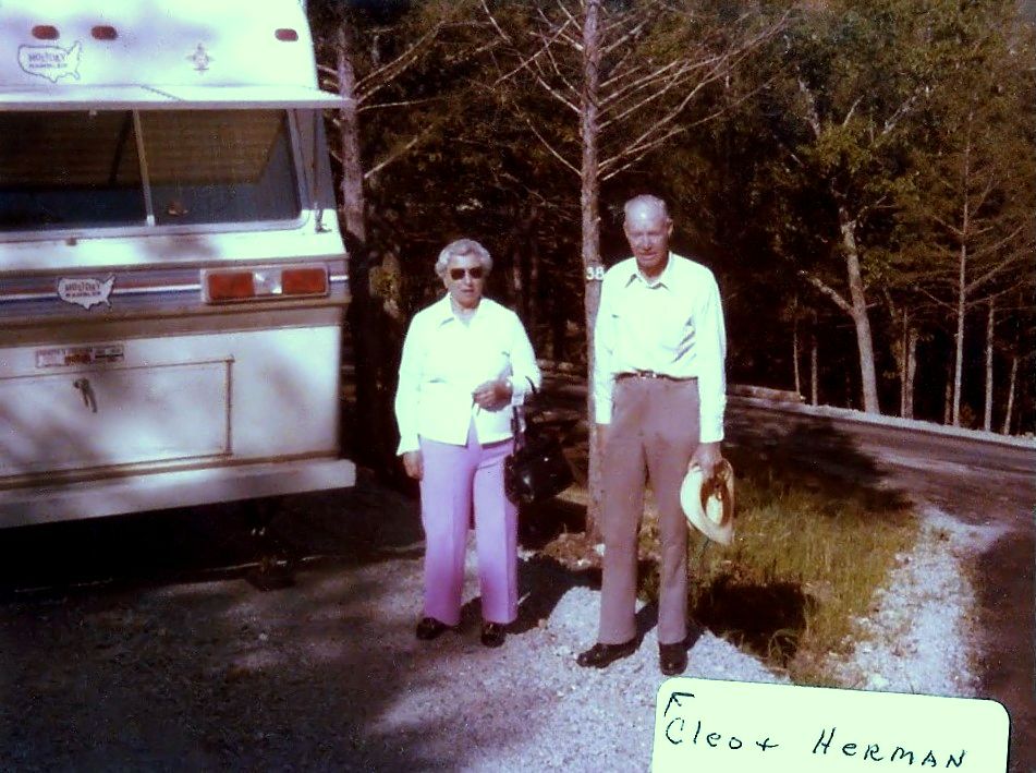 Cleo and Herman by their travel trailer, late 1970s